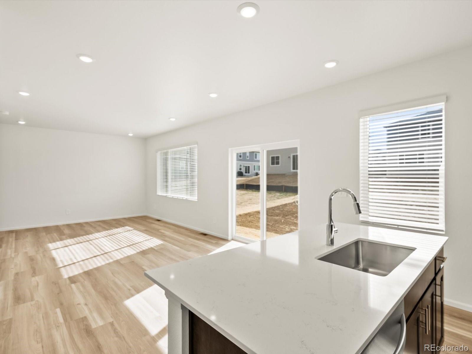 7343 West 27th Street Greeley, CO 80634 - Photo 12 of 29 a kitchen with a sink a stove and a refrigerator