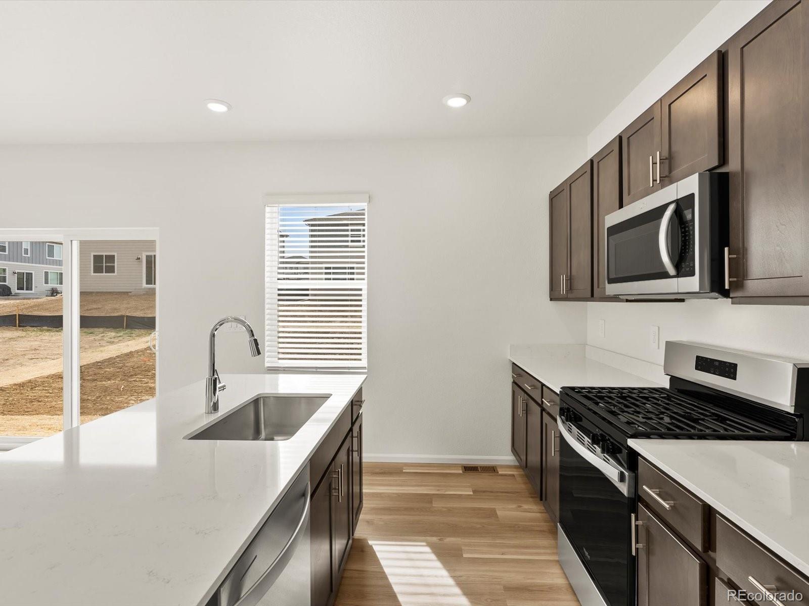 7343 West 27th Street Greeley, CO 80634 - Photo 8 of 29 a kitchen that has a sink and a stove