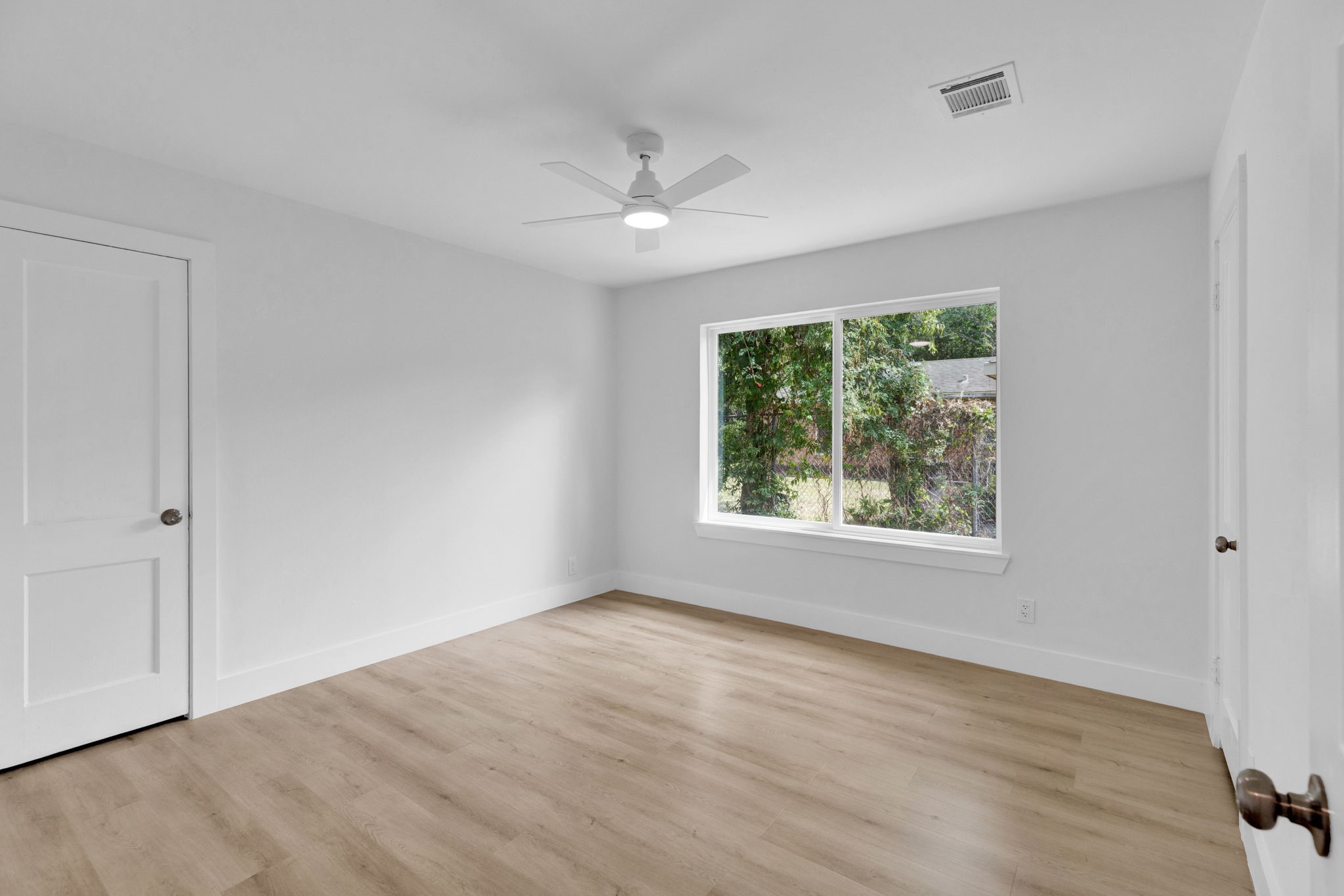 3511 Arbor Street Houston, TX 77004 - Photo 11 of 17 a view of an empty room with wooden floor and a window