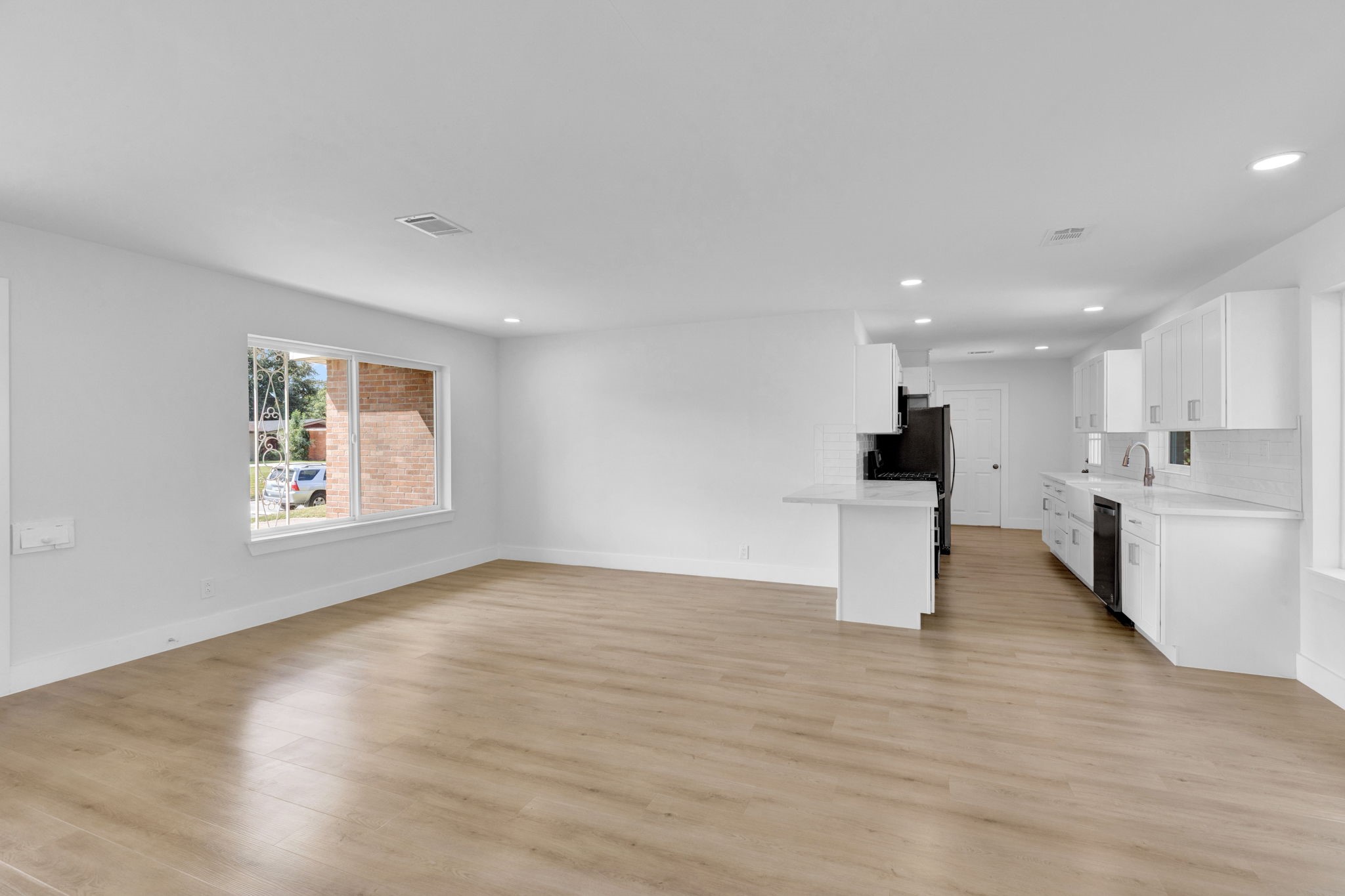 3511 Arbor Street Houston, TX 77004 - Photo 4 of 17 a view of an empty room with kitchen and window