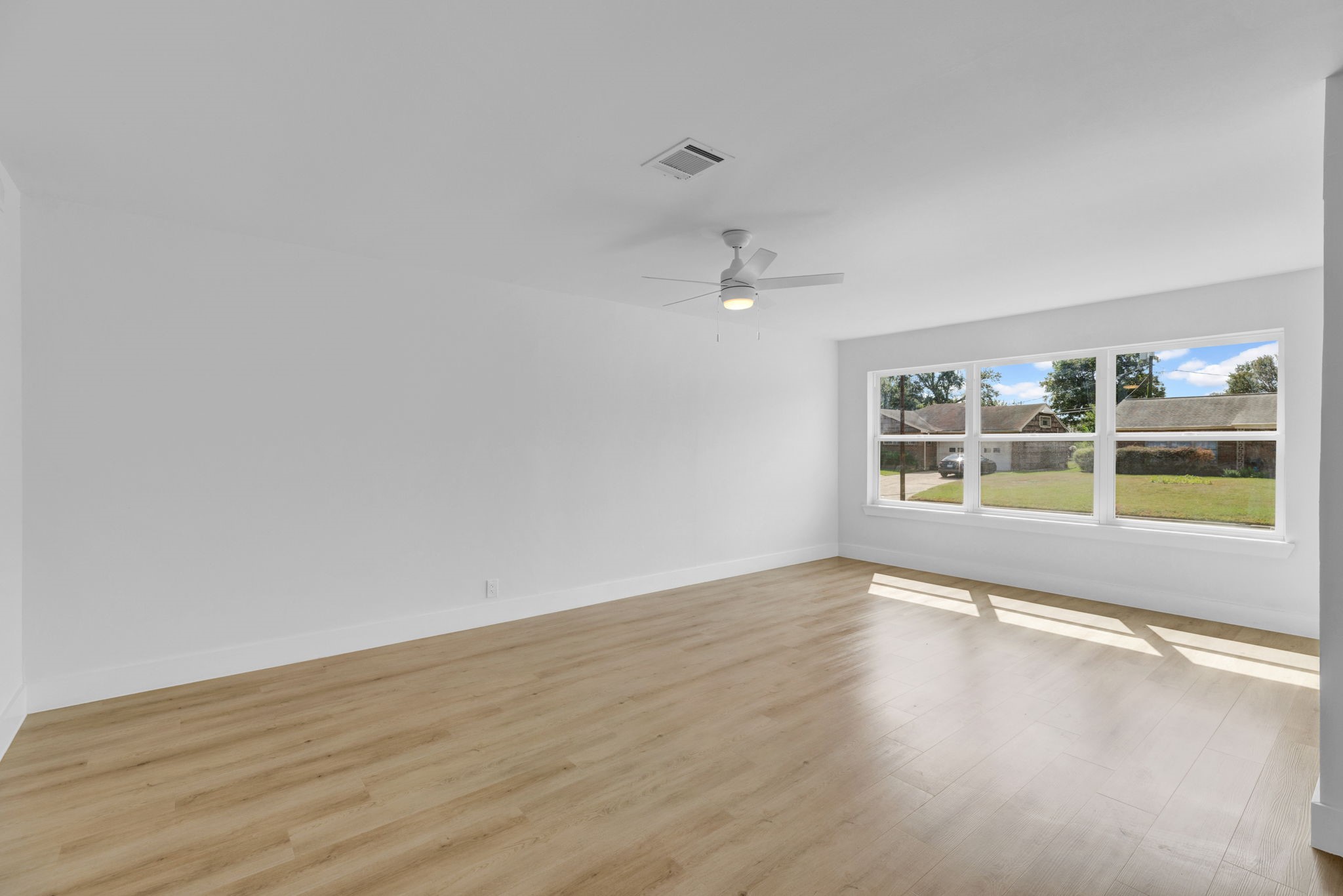 3511 Arbor Street Houston, TX 77004 - Photo 5 of 17 a view of an empty room with a window and wooden floor