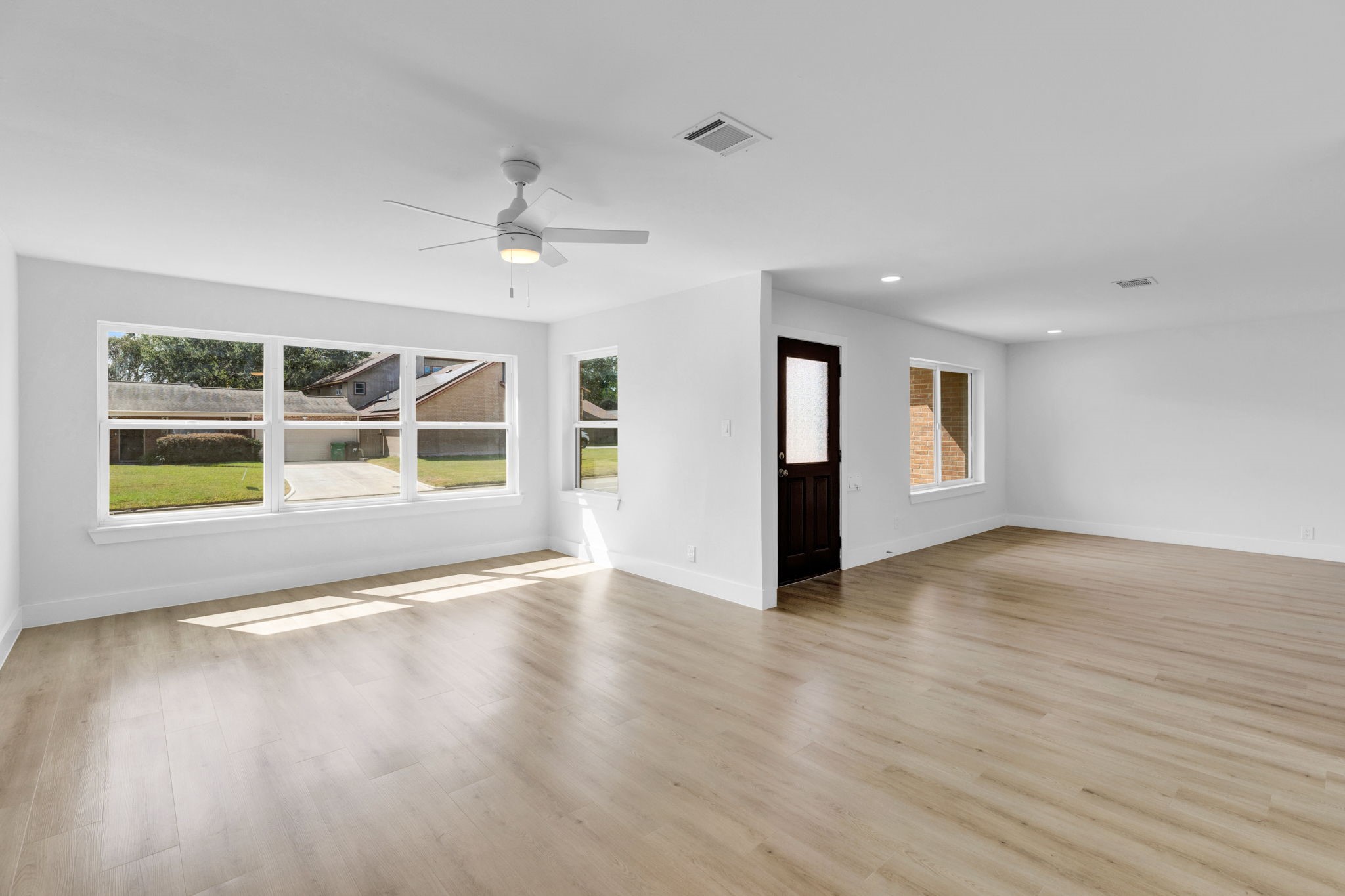 3511 Arbor Street Houston, TX 77004 - Photo 6 of 17 a view of an empty room with a window and wooden floor