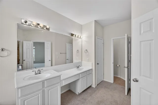 a bathroom with a double vanity sink mirror and double