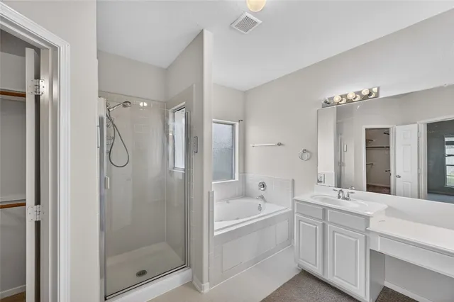 a bathroom with a double vanity sink mirror and shower