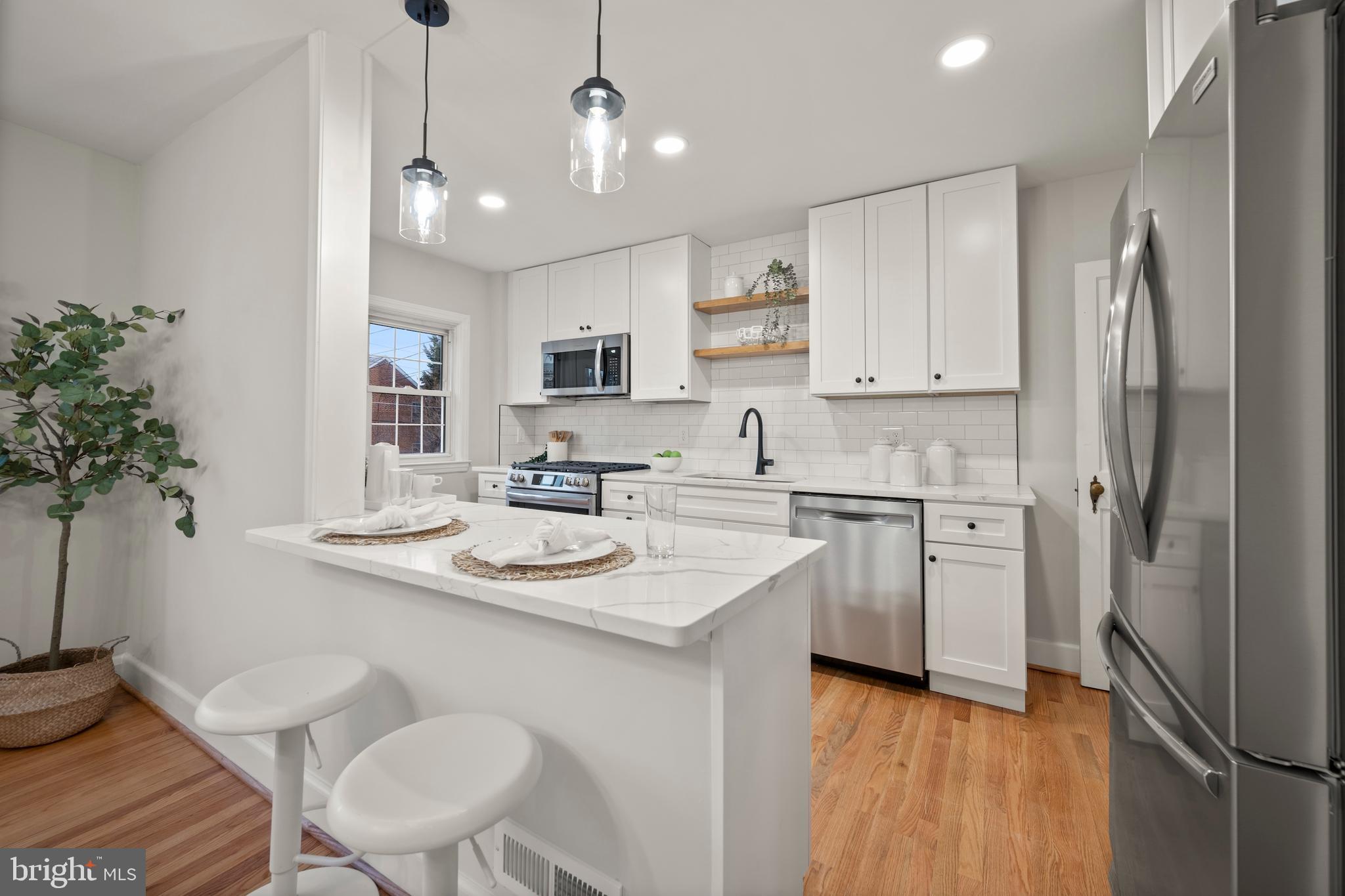 323 Stratford Road Baltimore, MD 21228 - Photo 11 of 35 a kitchen with a sink stove and refrigerator