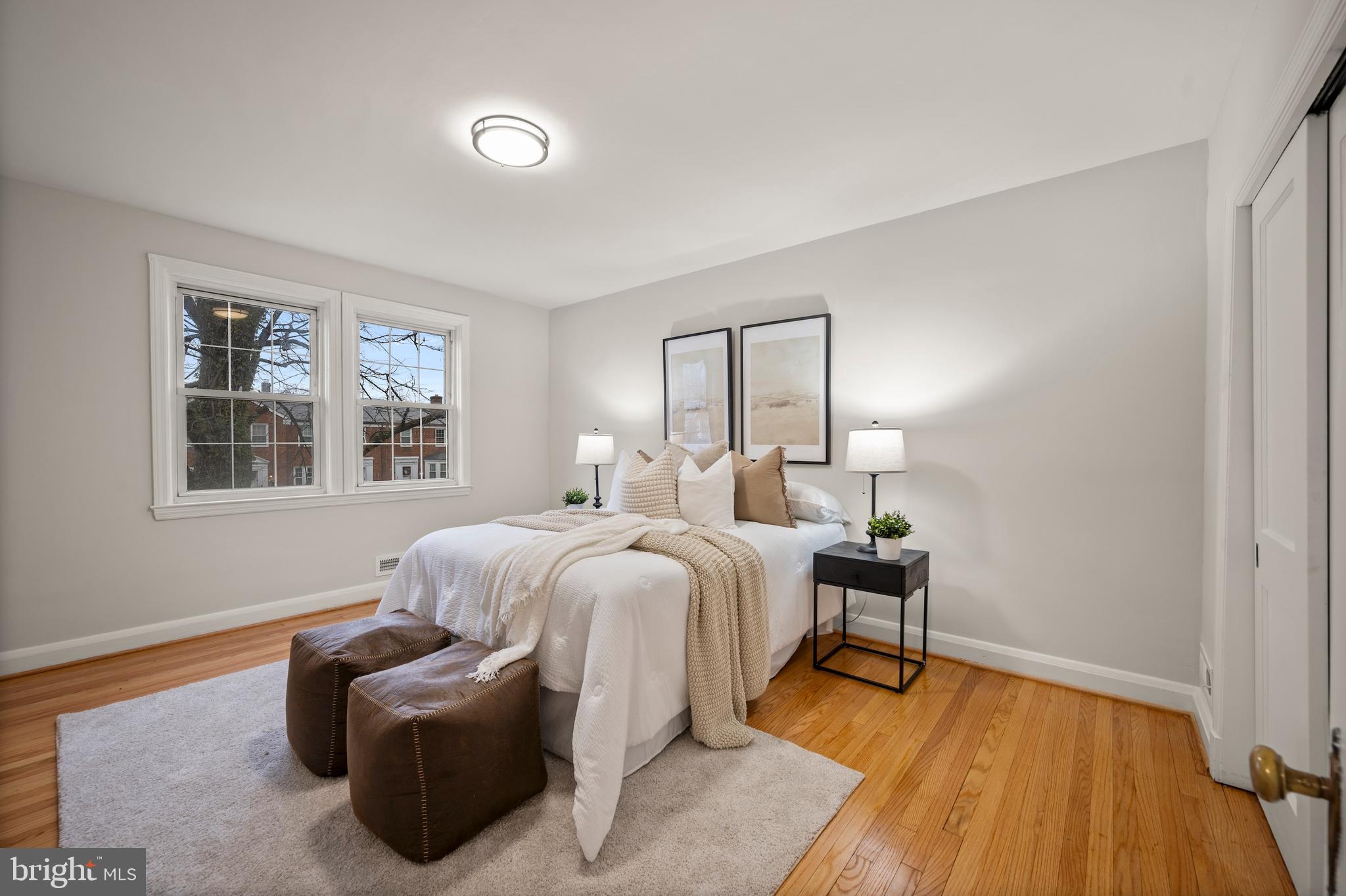 323 Stratford Road Baltimore, MD 21228 - Photo 13 of 35 a spacious bedroom with a bed and wooden floor