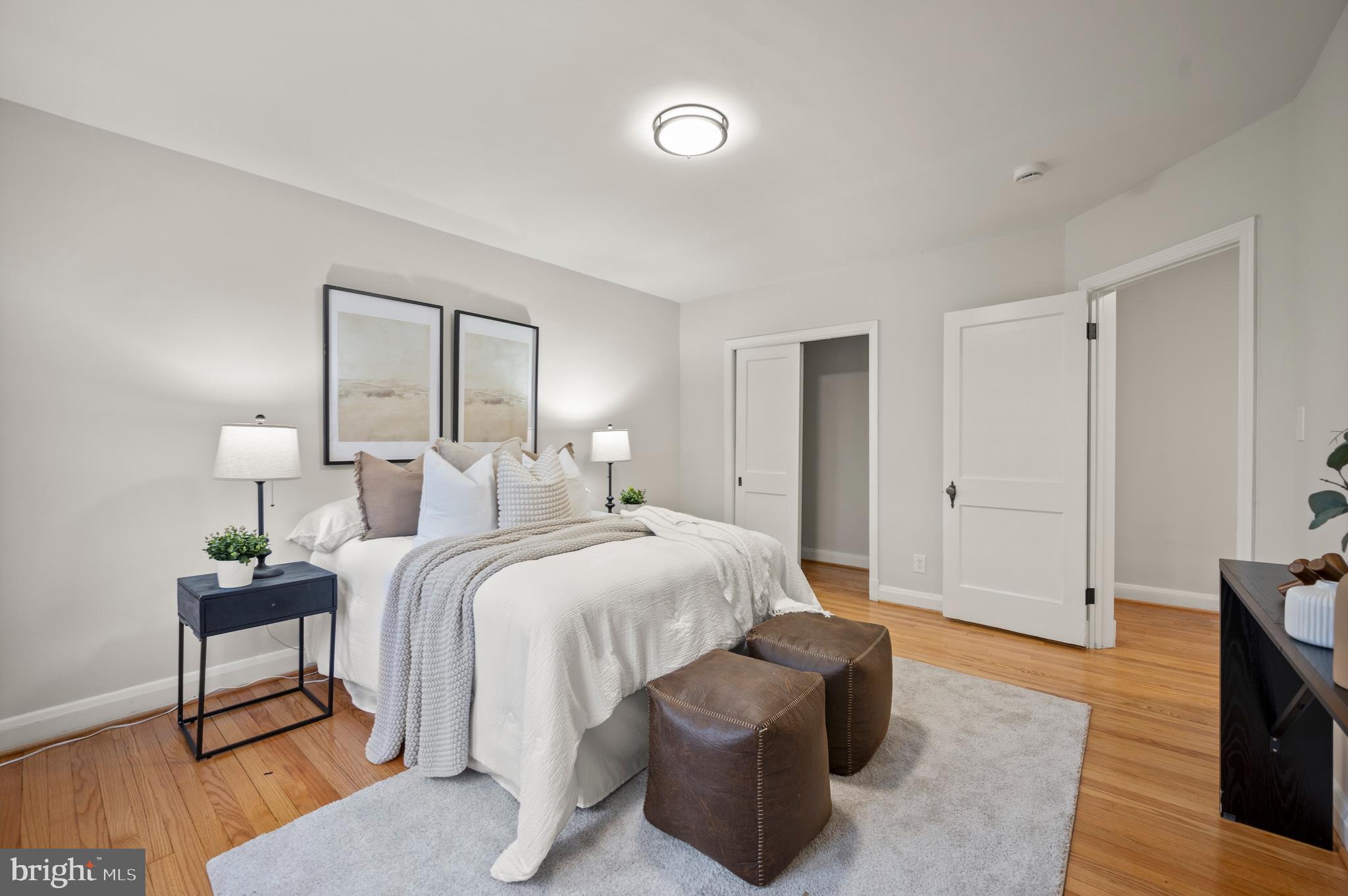 323 Stratford Road Baltimore, MD 21228 - Photo 14 of 35 a spacious bedroom with a bed and a lamp on table