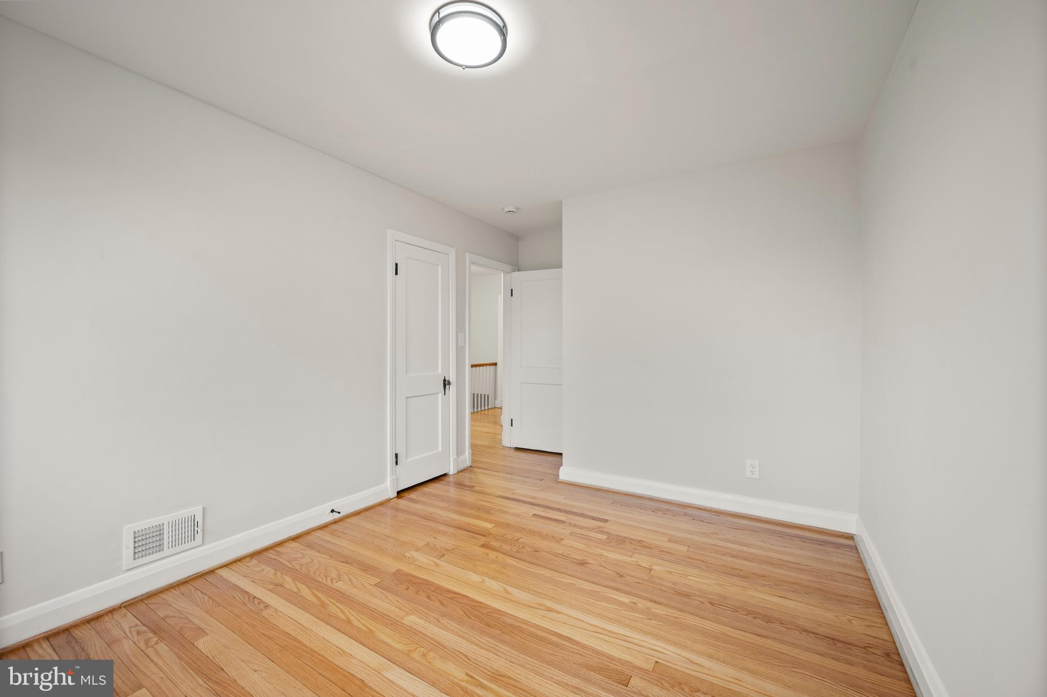 323 Stratford Road Baltimore, MD 21228 - Photo 17 of 35 a view of empty room with wooden floor