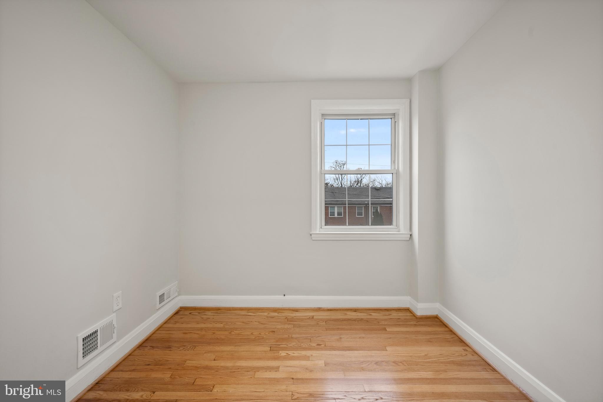 323 Stratford Road Baltimore, MD 21228 - Photo 18 of 35 a view of an empty room with wooden floor and a window