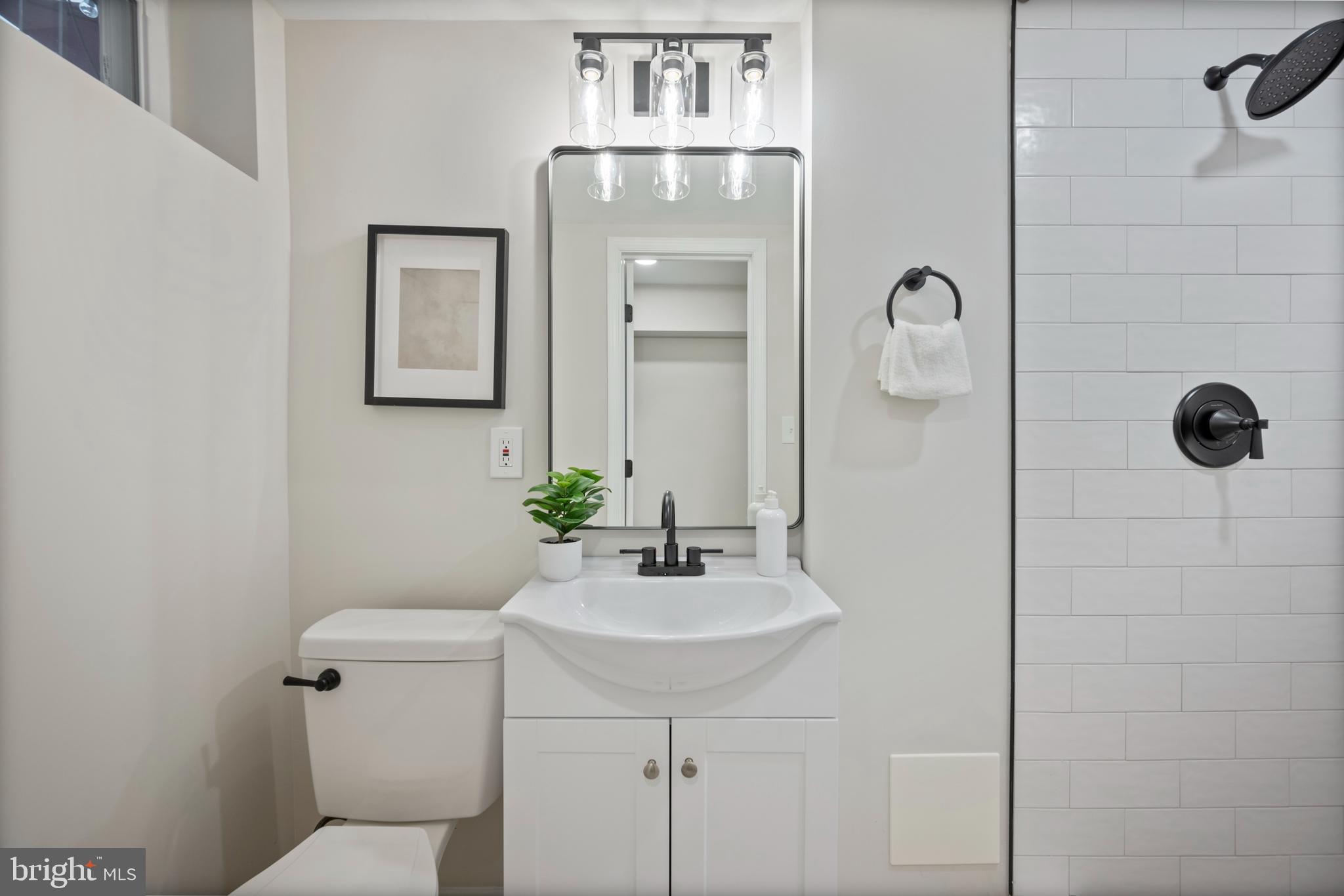 323 Stratford Road Baltimore, MD 21228 - Photo 21 of 35 a bathroom with a sink a toilet and mirror