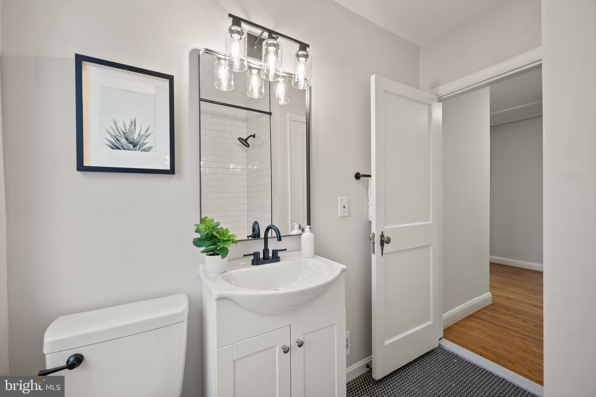 323 Stratford Road Baltimore, MD 21228 - Photo 23 of 35 a bathroom with a sink a toilet and shower