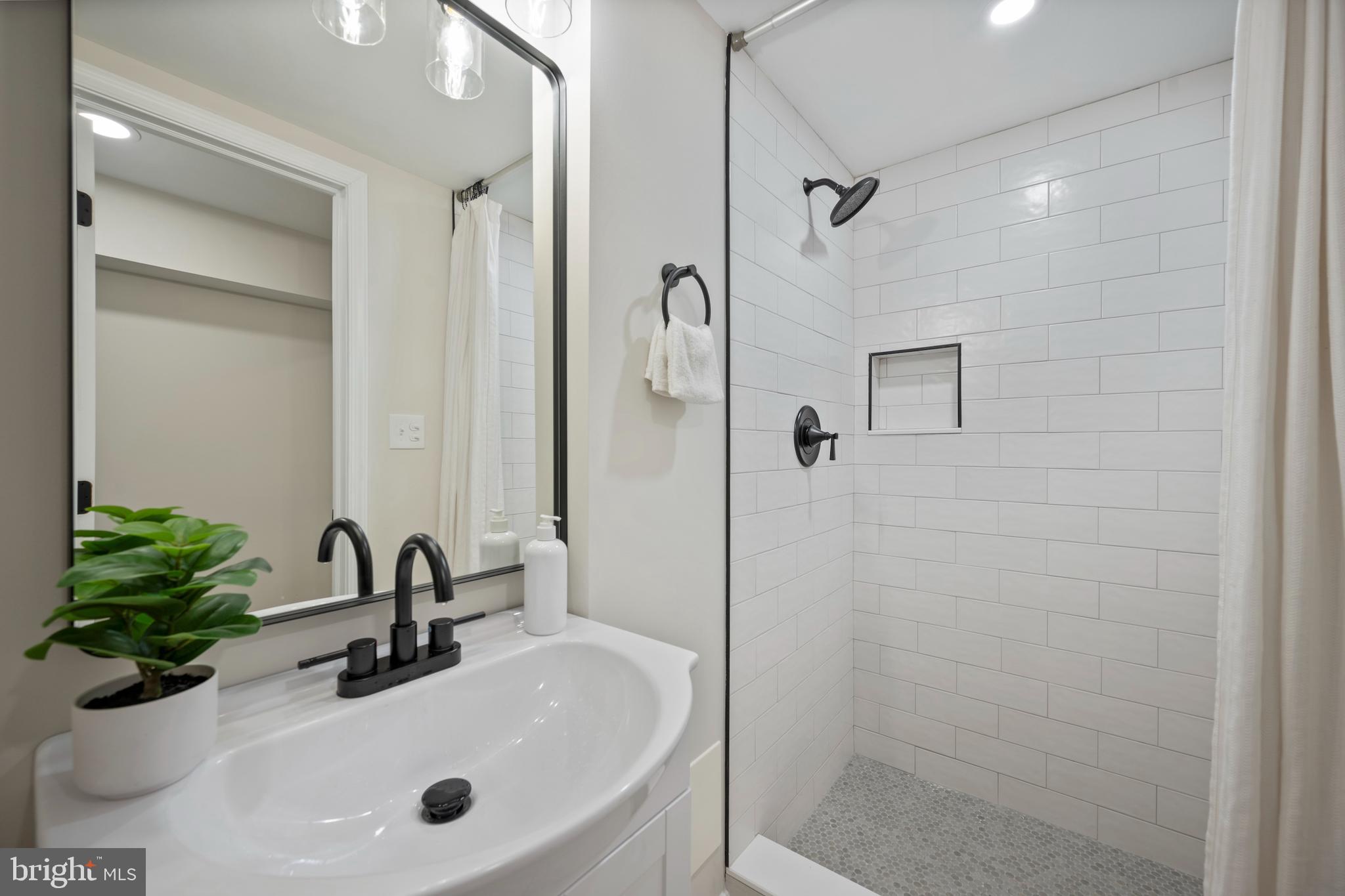 323 Stratford Road Baltimore, MD 21228 - Photo 26 of 35 a bathroom with a sink shower and a mirror