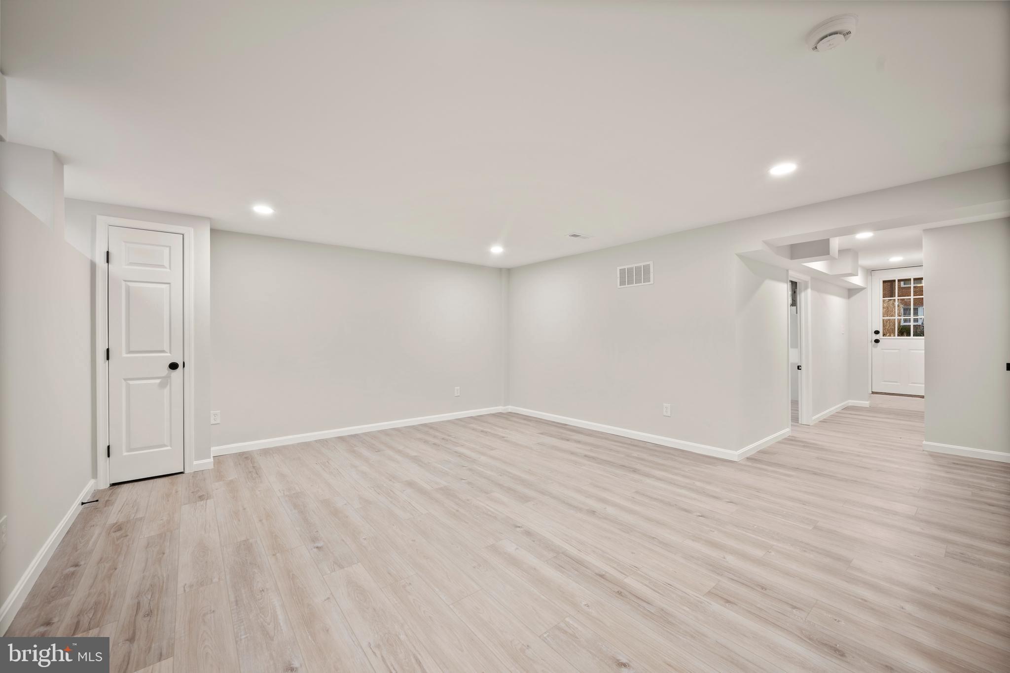 323 Stratford Road Baltimore, MD 21228 - Photo 27 of 35 a view of an empty room with wooden floor