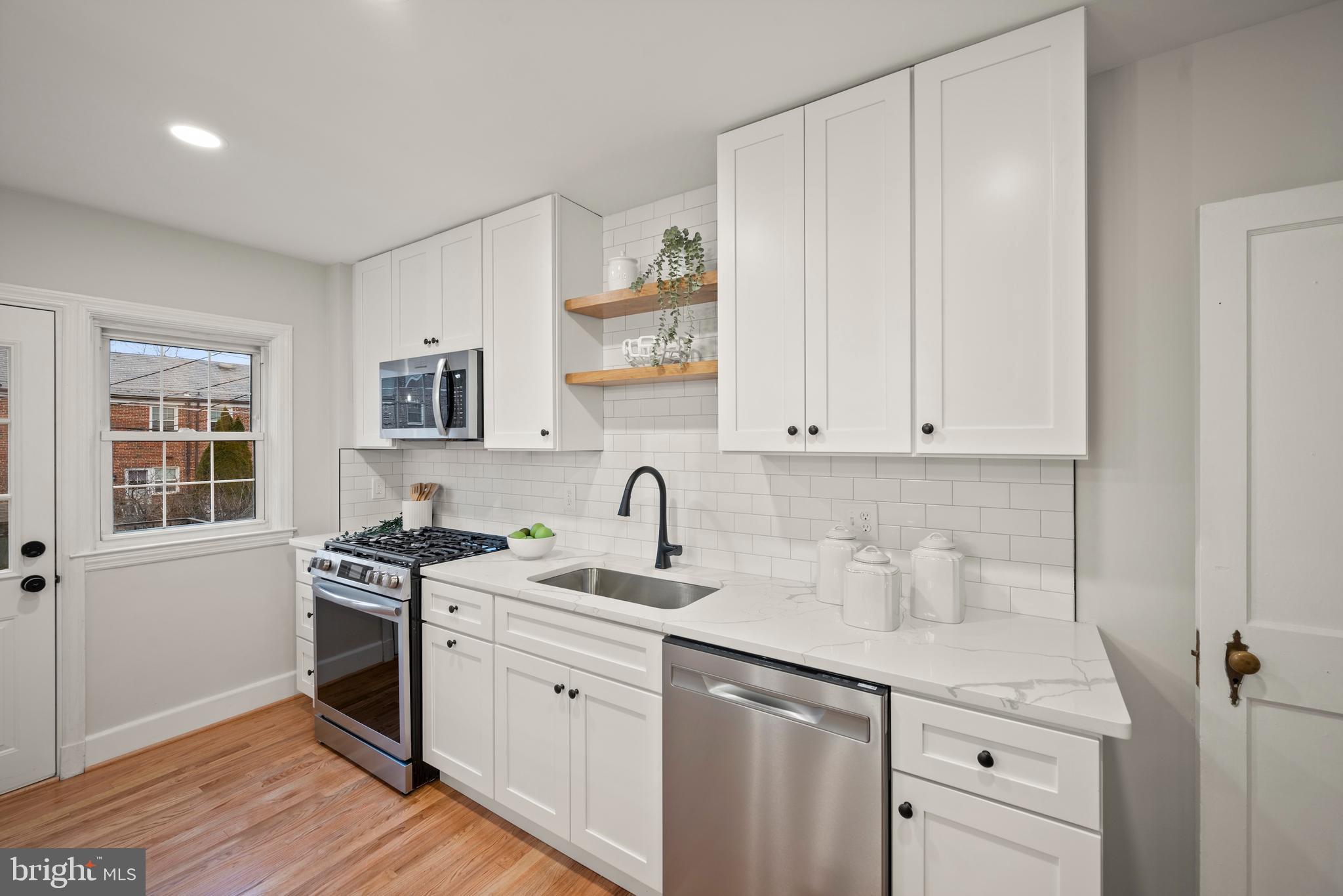 323 Stratford Road Baltimore, MD 21228 - Photo 6 of 35 a kitchen with a sink stove and cabinets