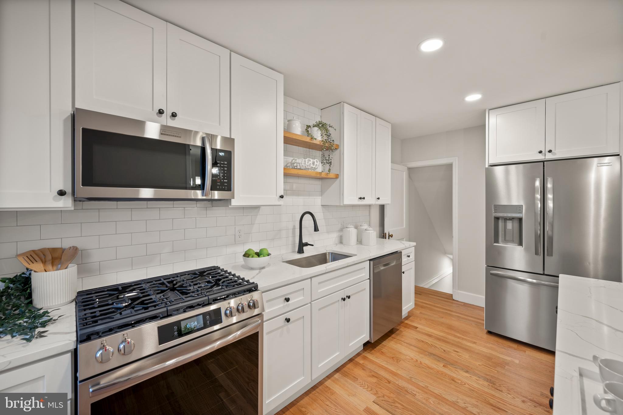 323 Stratford Road Baltimore, MD 21228 - Photo 7 of 35 a kitchen with stainless steel appliances a stove a sink and a refrigerator