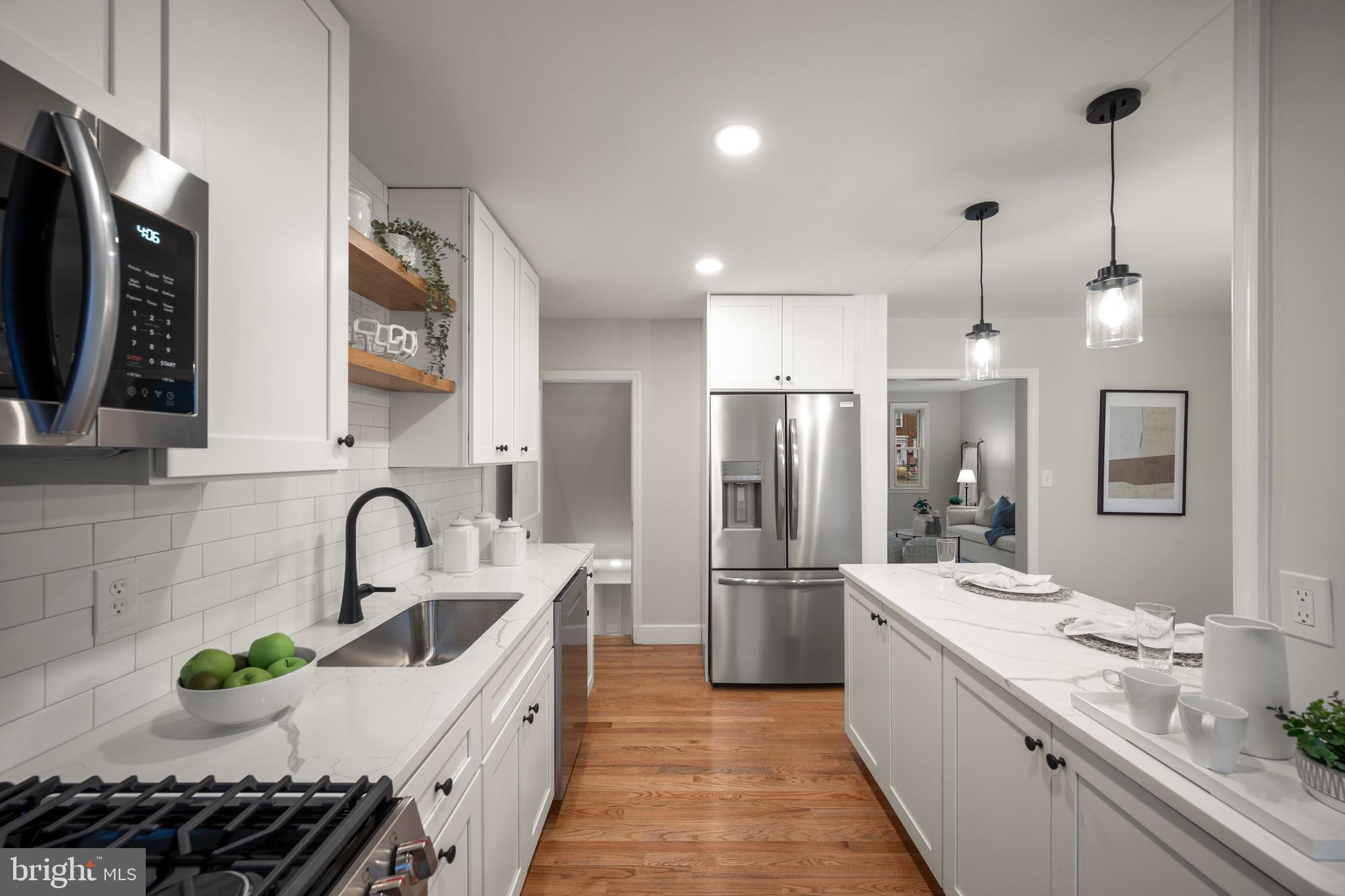 323 Stratford Road Baltimore, MD 21228 - Photo 8 of 35 a kitchen with granite countertop a sink stainless steel appliances and cabinets