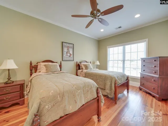a spacious bedroom with two beds and a dresser