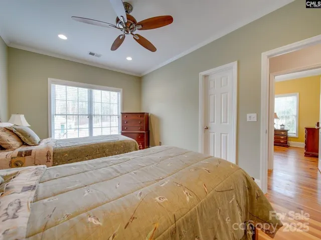 a spacious bedroom with a bed and a window