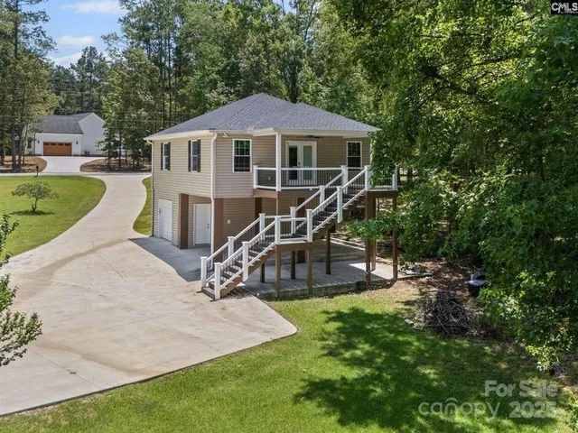 a view of a house with swimming pool and sitting area