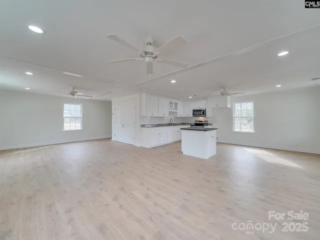 a view of a kitchen with a sink and microwave