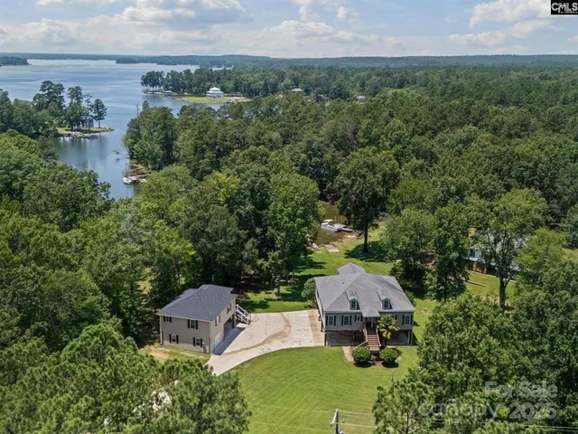an aerial view of a house with a yard