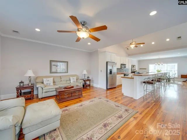 a living room with furniture and kitchen view