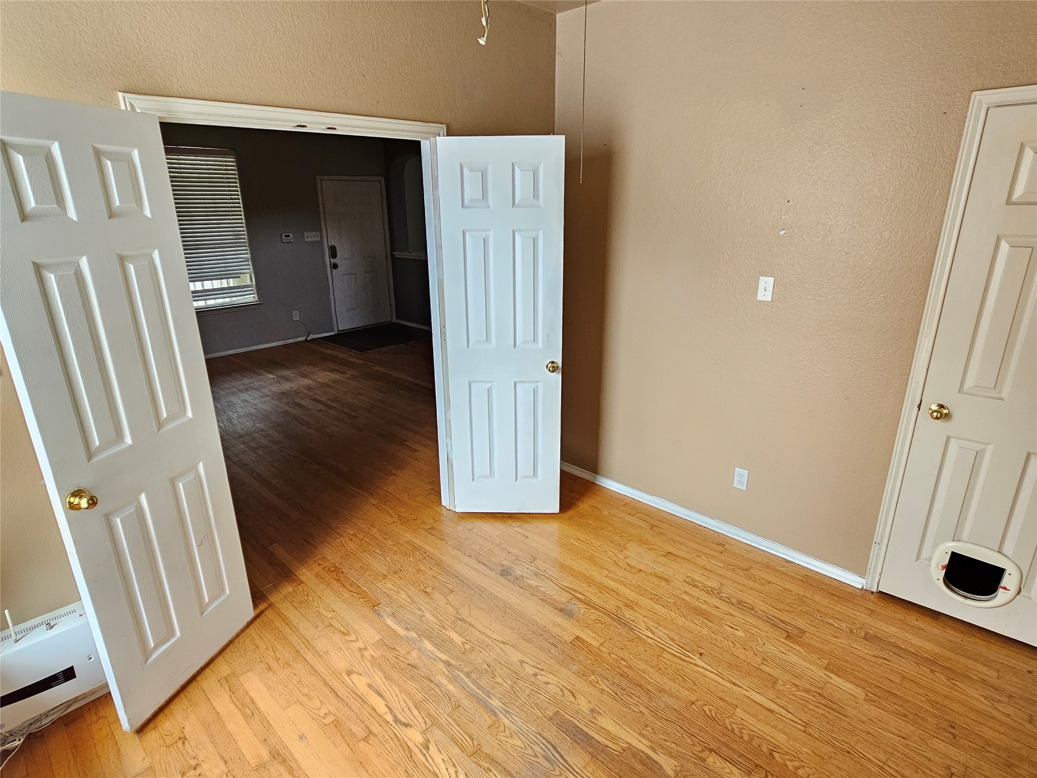 4672 Mather Kyle, TX 78640 - Photo 13 of 28 a view of an empty room with wooden floor and a window