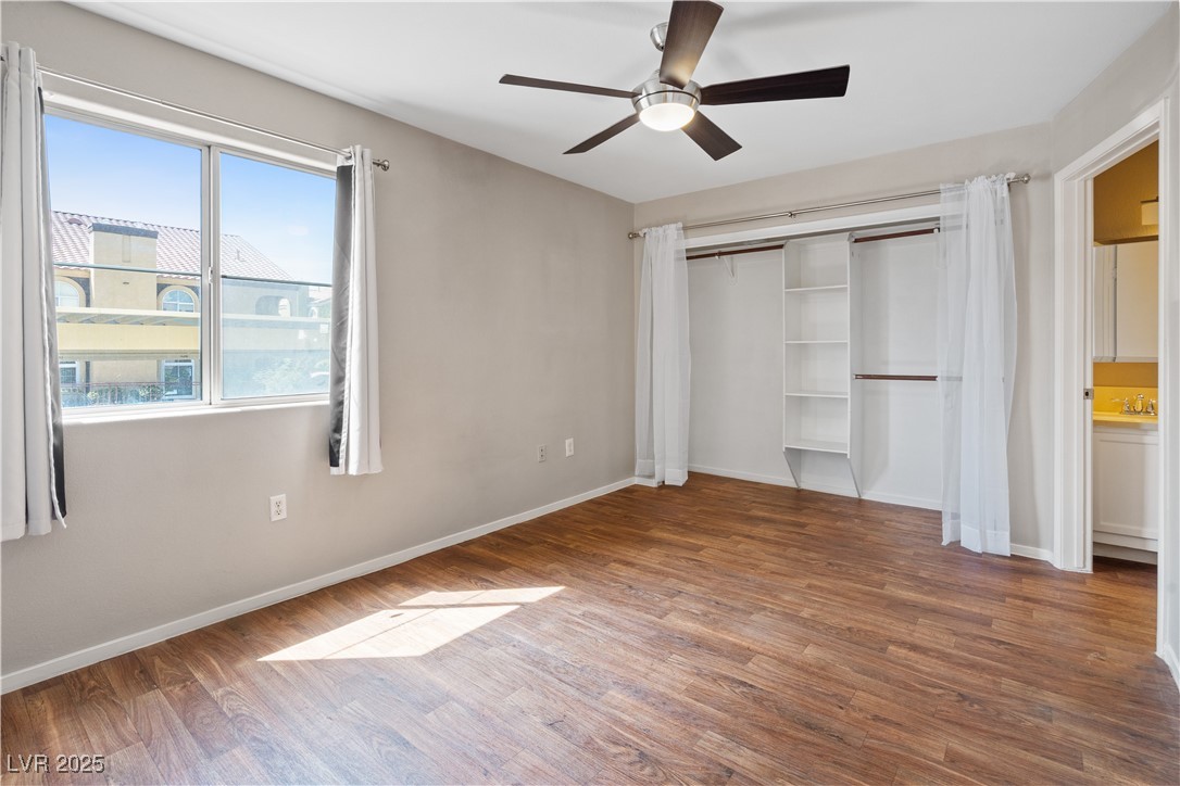 7950 West Flamingo Road, Unit 1039 Las Vegas, NV 89147 - Photo 12 of 26 Unfurnished bedroom with wood finished floors, a closet, and a ceiling fan