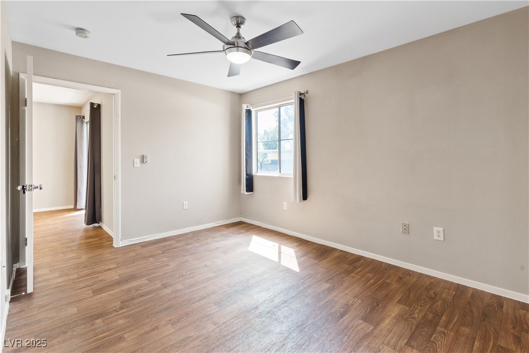 7950 West Flamingo Road, Unit 1039 Las Vegas, NV 89147 - Photo 13 of 26 Spare room with wood finished floors and a ceiling fan