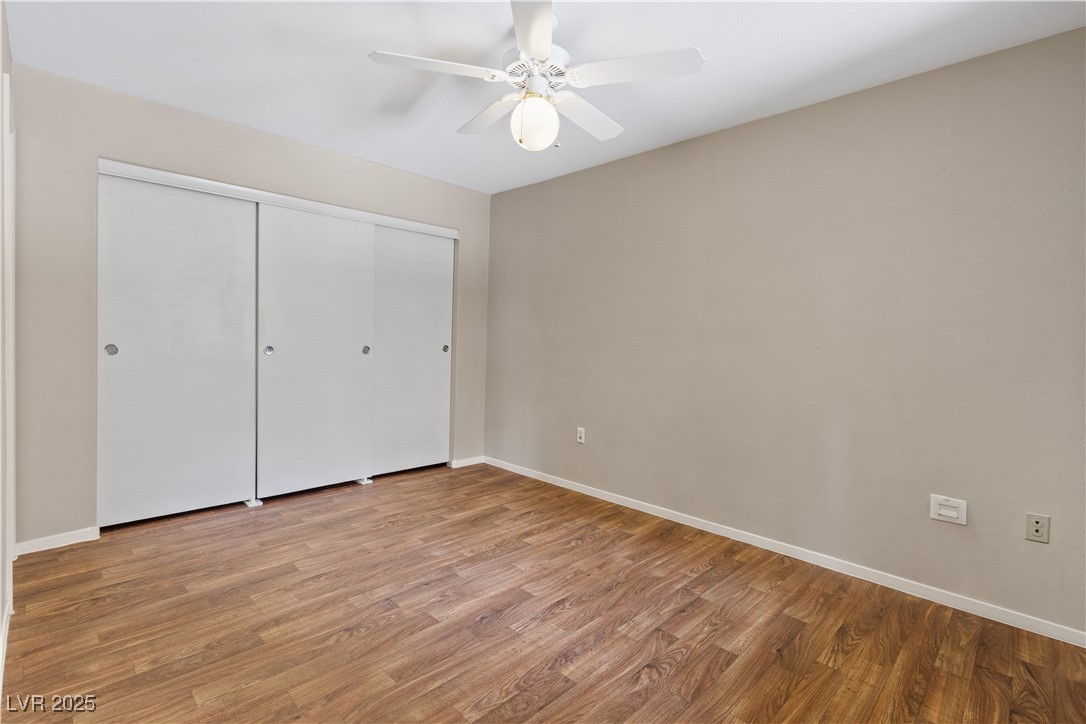 7950 West Flamingo Road, Unit 1039 Las Vegas, NV 89147 - Photo 17 of 26 Unfurnished bedroom with light wood-type flooring, a closet, and a ceiling fan