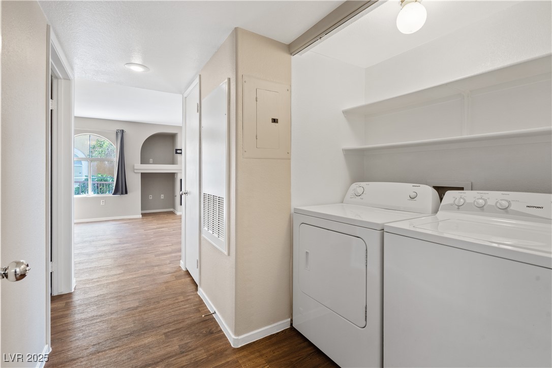 7950 West Flamingo Road, Unit 1039 Las Vegas, NV 89147 - Photo 20 of 26 Laundry area featuring dark wood-style floors, electric panel, and washing machine and clothes dryer