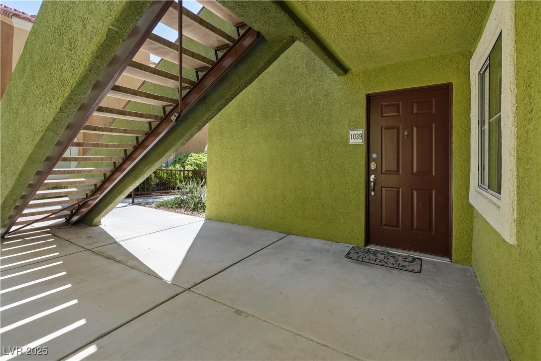 7950 West Flamingo Road, Unit 1039 Las Vegas, NV 89147 - Photo 23 of 26 View of exterior entry with stucco siding and a patio area
