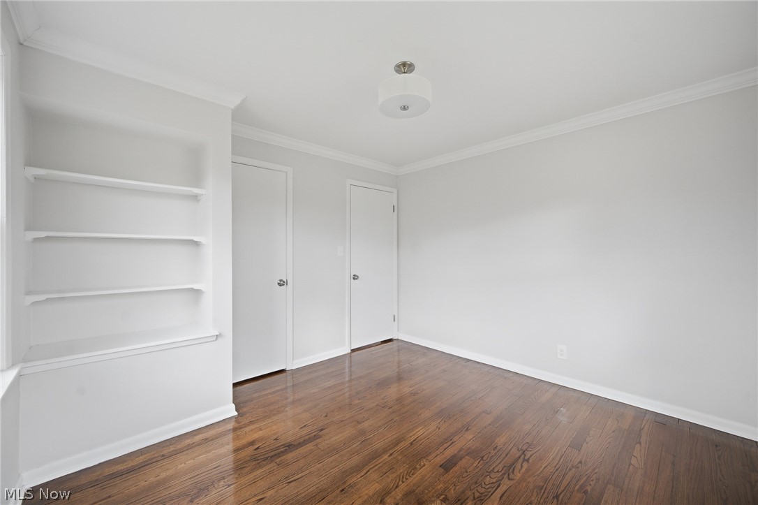3722 Lindholm Road Shaker Heights, OH 44120 - Photo 27 of 34 This room features rich hardwood flooring, built-in shelving, two doors, and a ceiling light fixture