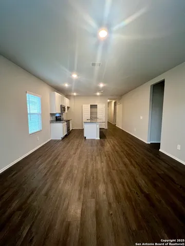 a kitchen with granite countertop white cabinets and a stainless steel appliances
