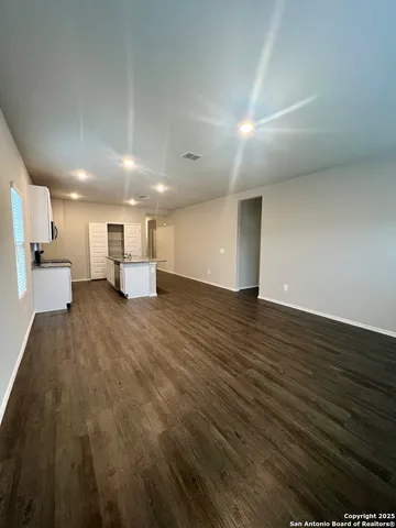a kitchen with a sink a stove and cabinets
