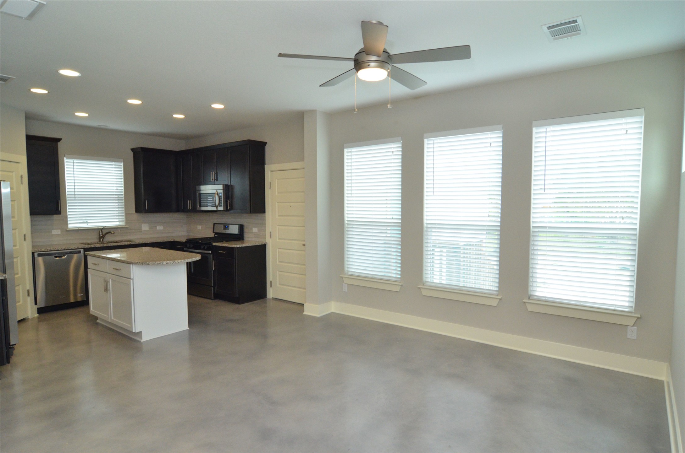 1916 Cleese Drive Austin, TX 78741 - Photo 5 of 36 An open concept design seamlessly connects this kitchen and living space, ideal for modern entertaining.