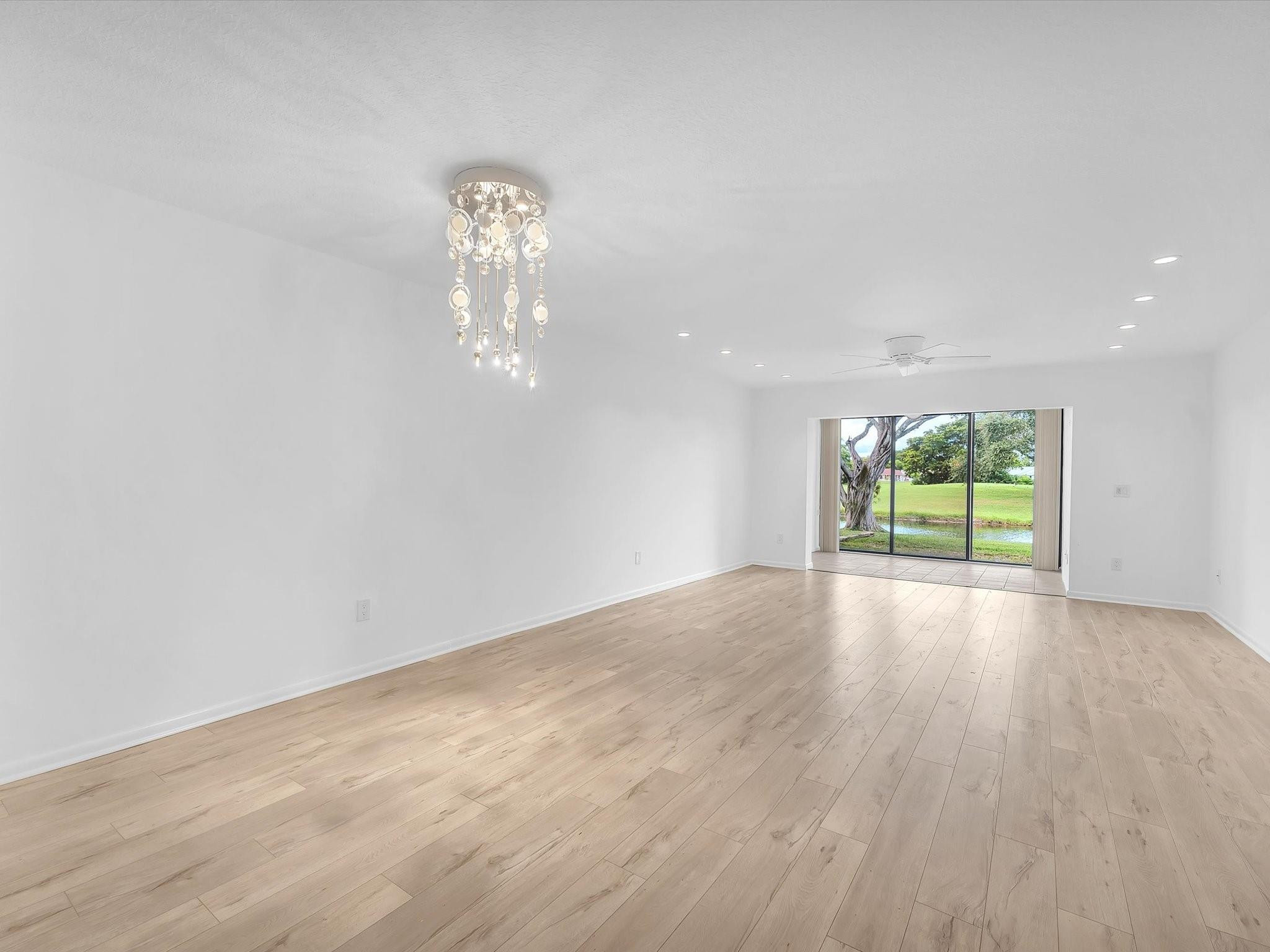9290 Vista Del Lago, Unit E Boca Raton, FL 33428 - Photo 9 of 39 Living room and dining area with den