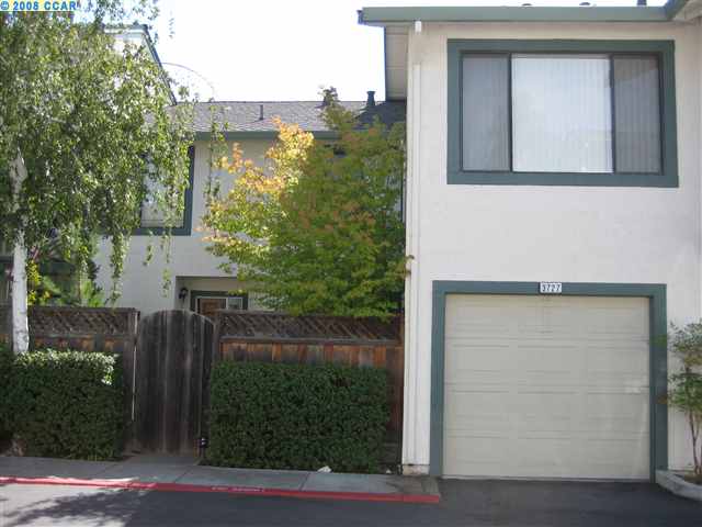 a view of a house with a small yard