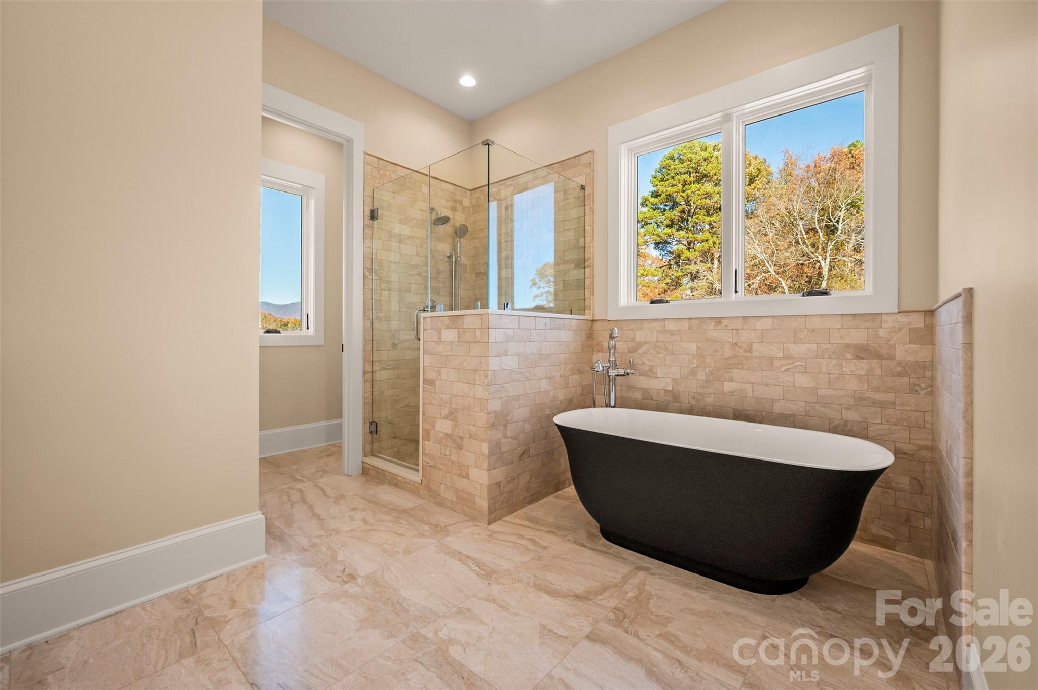 297 Mountain Meadows Lane, Unit 7 Tryon, NC 28782 - Photo 22 of 47 a bathroom with a bathtub and a shower