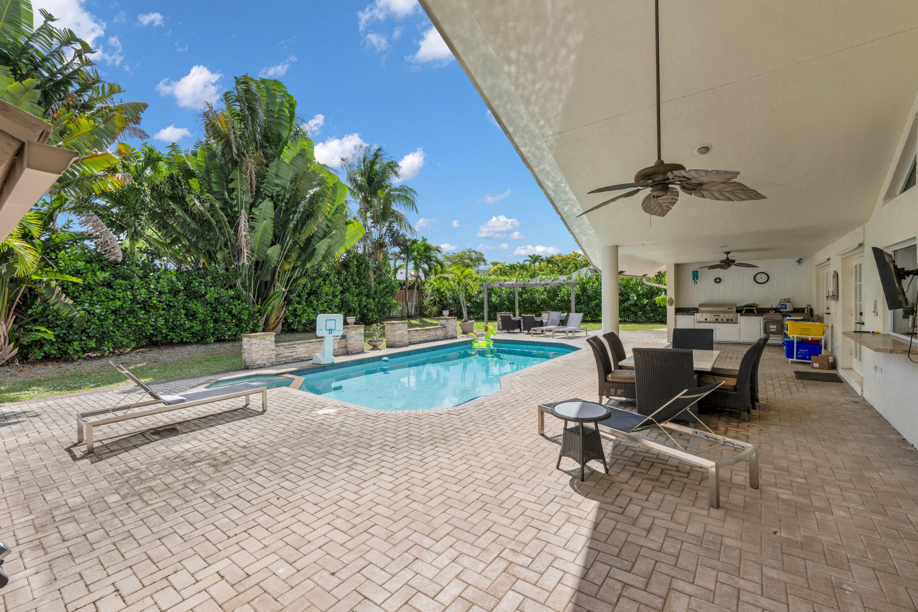 4320 St Charles Way Boca Raton, FL 33434 - Photo 11 of 34 a swimming pool with outdoor seating and yard