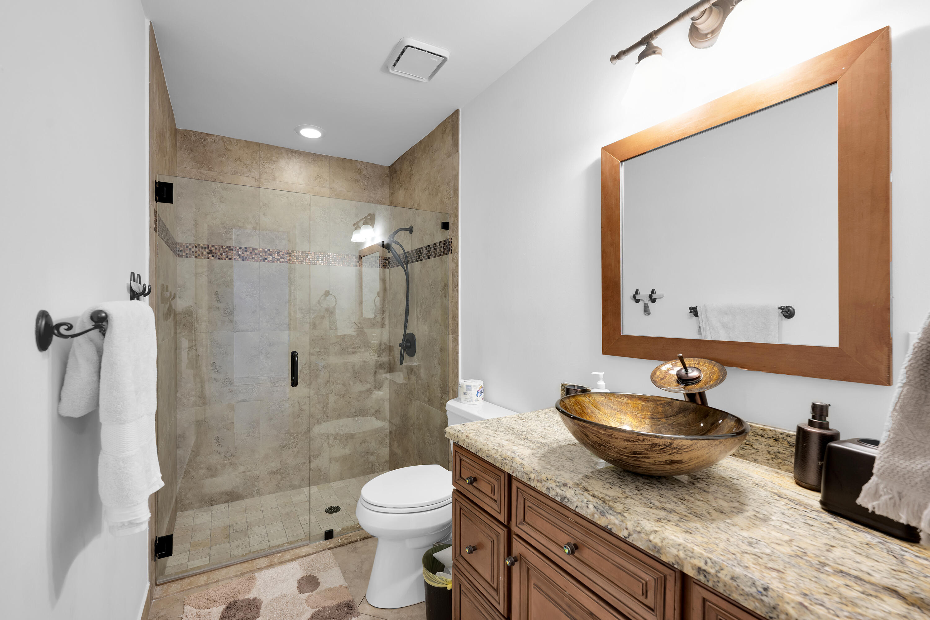 4320 St Charles Way Boca Raton, FL 33434 - Photo 26 of 34 a bathroom with a granite countertop sink a mirror a toilet and shower