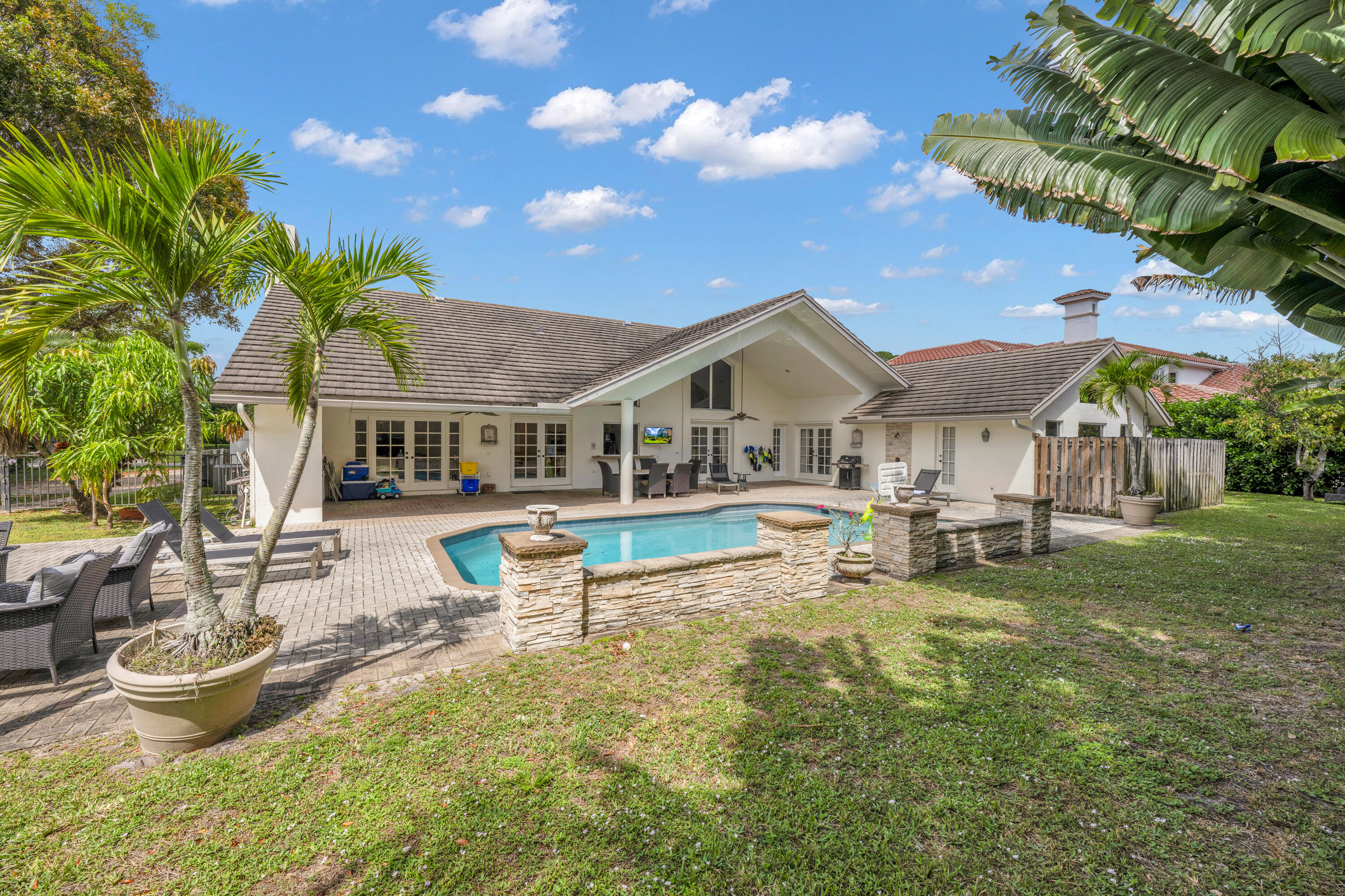 4320 St Charles Way Boca Raton, FL 33434 - Photo 28 of 34 a view of a house with backyard porch and sitting area