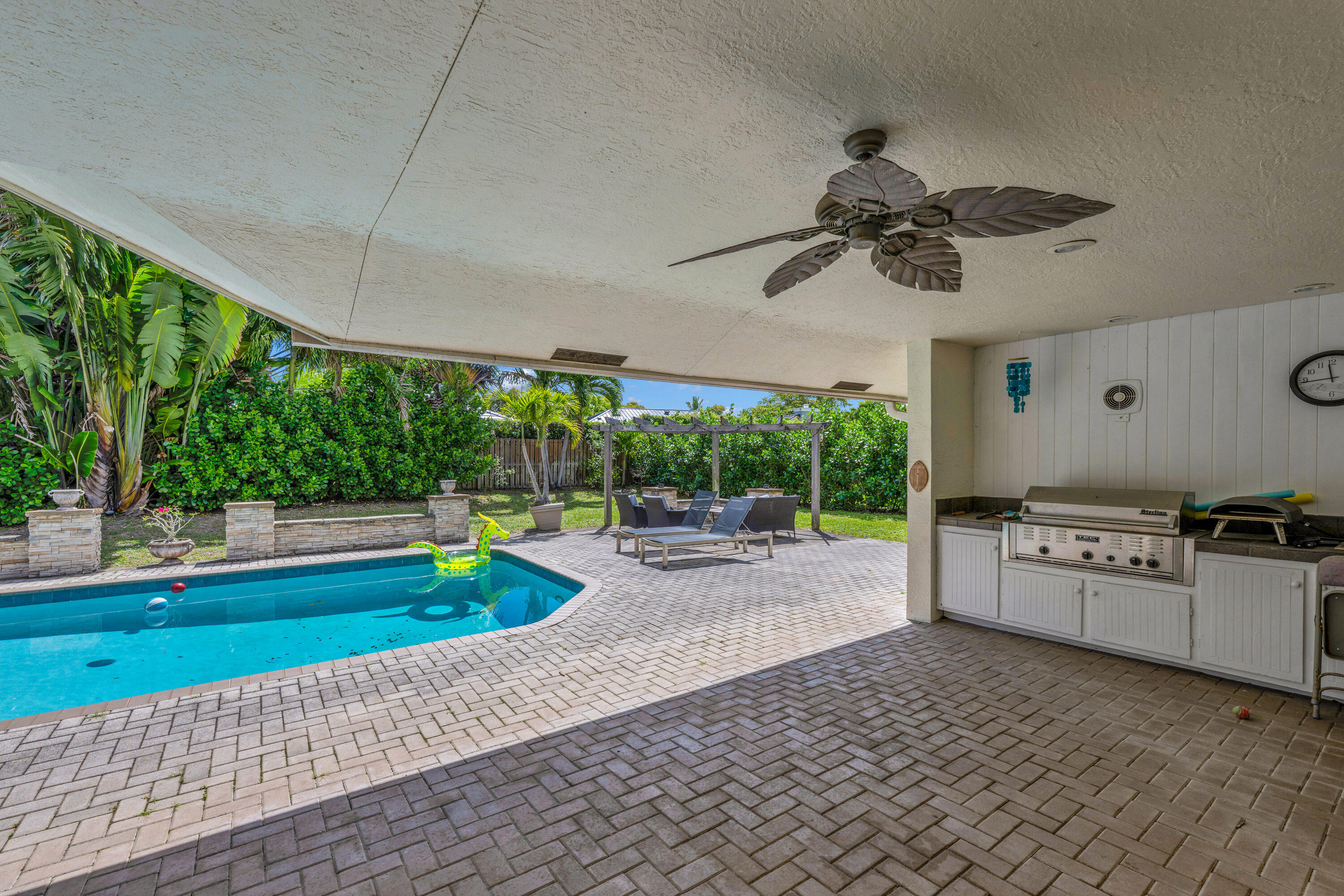 4320 St Charles Way Boca Raton, FL 33434 - Photo 30 of 34 a kitchen with kitchen island a stove and a large window
