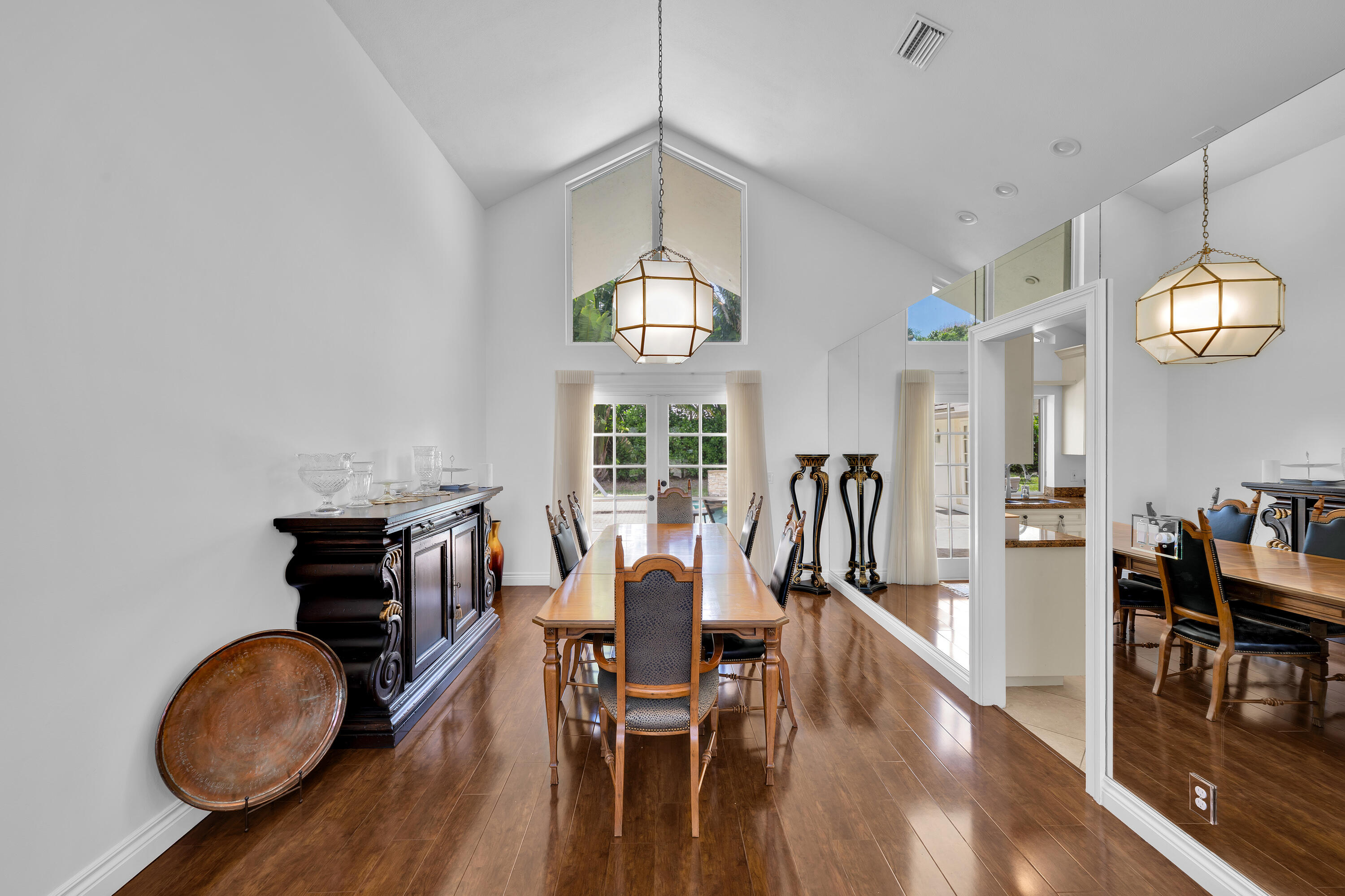 4320 St Charles Way Boca Raton, FL 33434 - Photo 7 of 34 a view of a dining room with furniture a chandelier and wooden floor