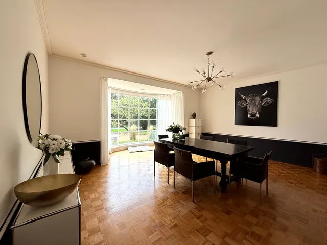 a living room with furniture a table and a large window