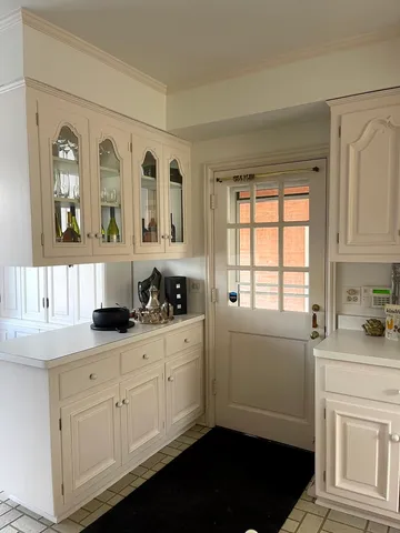 a kitchen with cabinets appliances and a window