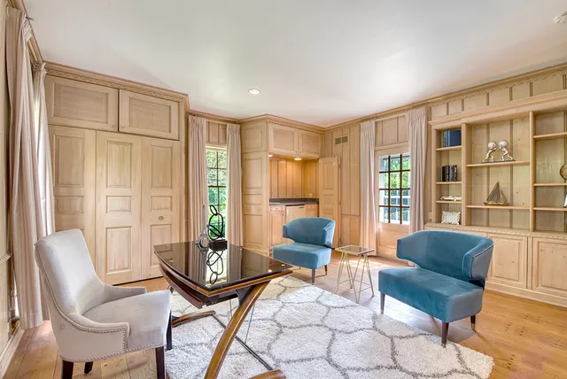 a living room with furniture and a floor to ceiling window