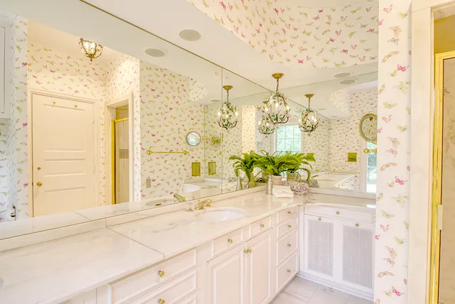 a bathroom with a double vanity sink mirror and shower