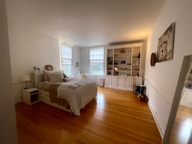 a spacious bedroom with a bed and a large window