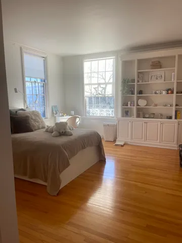 a bedroom with a bed and window